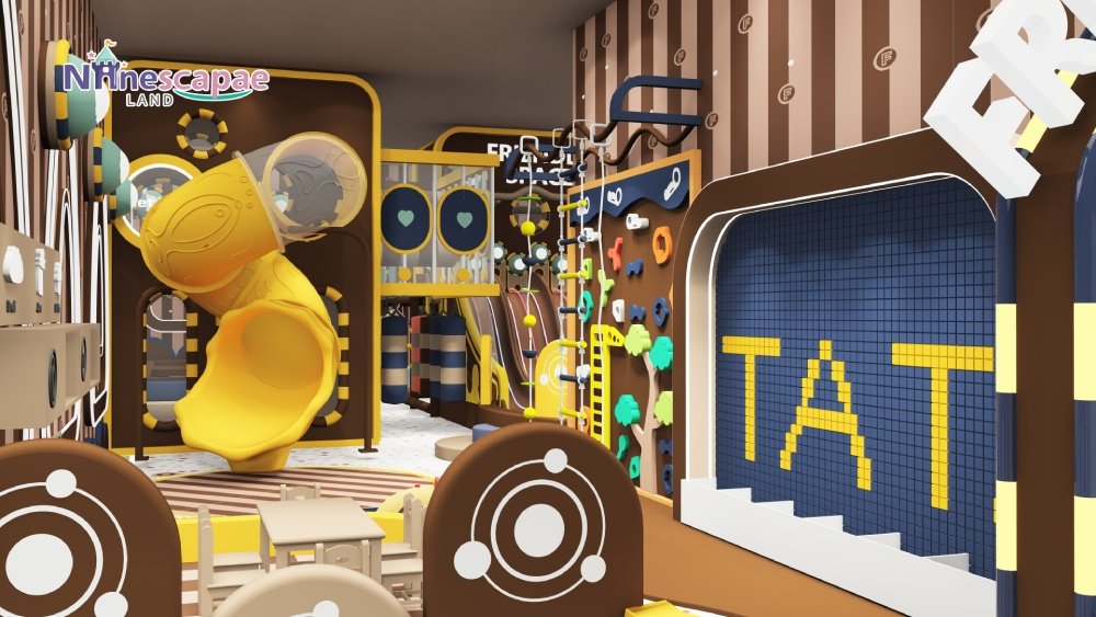 Indoor kids playground with yellow slides and climbing wall